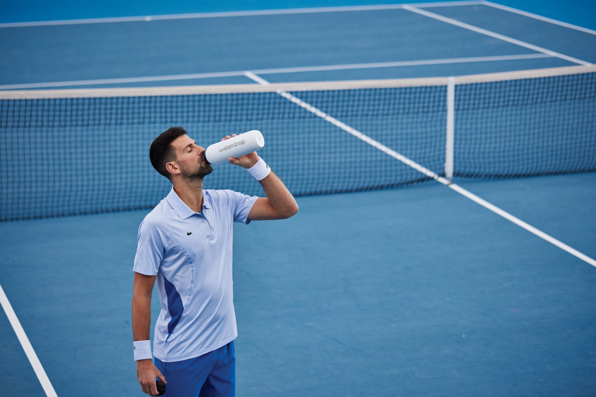 Novak Djokovic at Wimbledon 2023 drinking from a waterdrop bottle