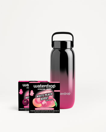 Reusable bottle with a black cap and pink gradient, shown with two small boxed flavor sachets.