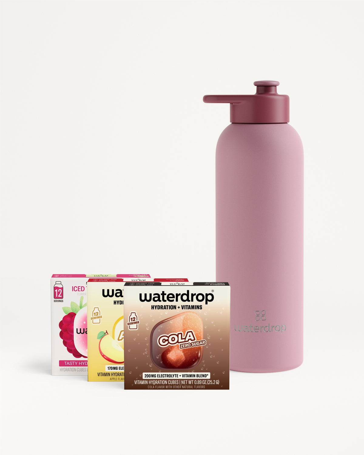 Pink reusable water bottle with a spout beside a row of small boxed drinks.