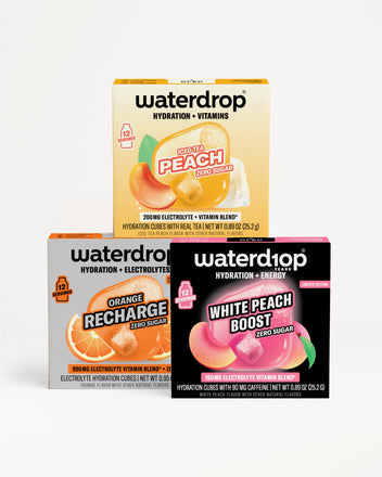 Three Waterdrop boxes stacked in a pyramid with yellow, orange, and black-purple packaging and fruit graphics.