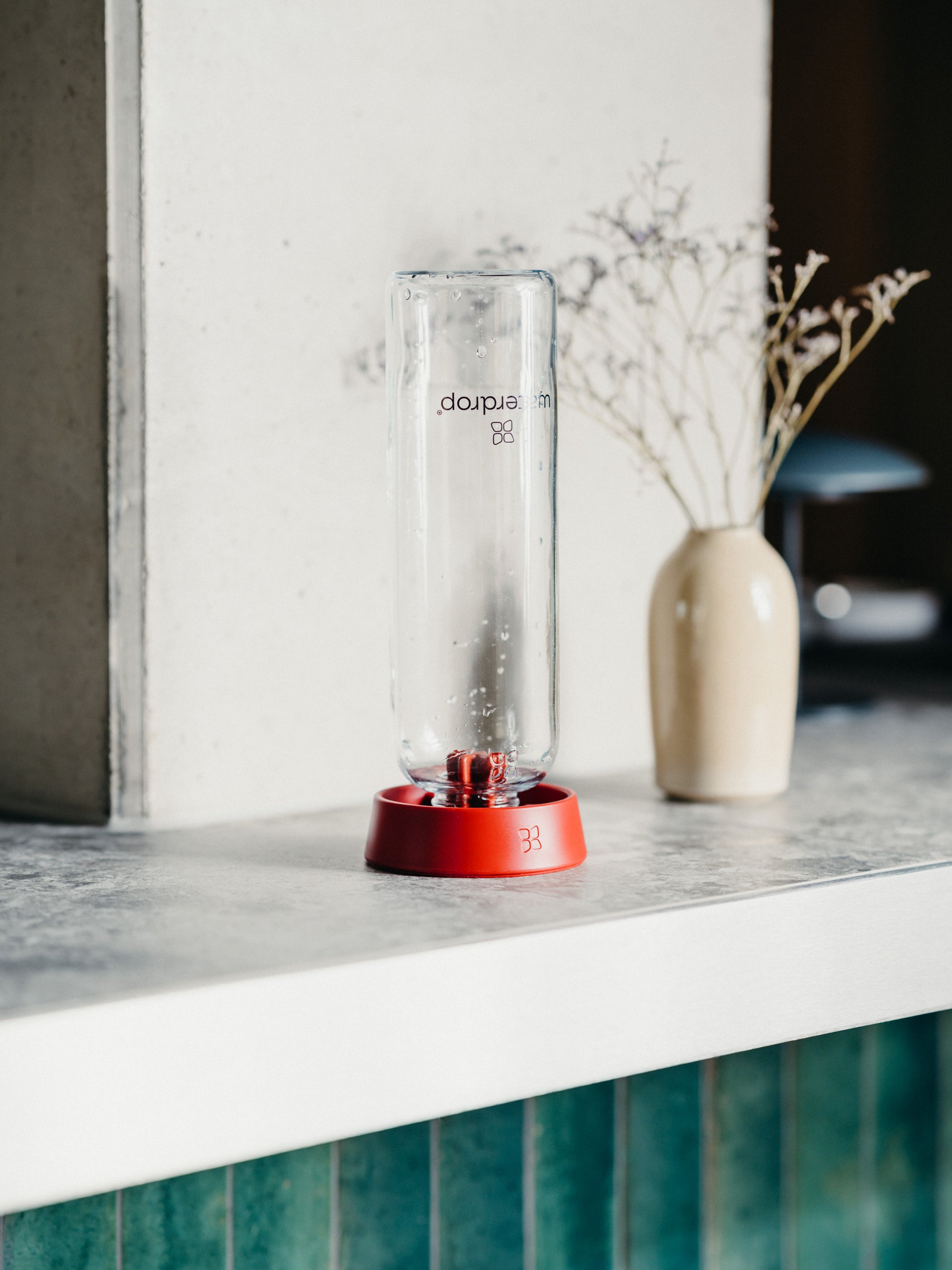 waterdrop® Glass Bottle standing on a bottle dryer on a kitchen countertop