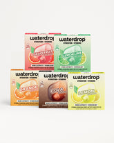 Assorted Waterdrop hydration and vitamin boxes stacked in a pyramid.