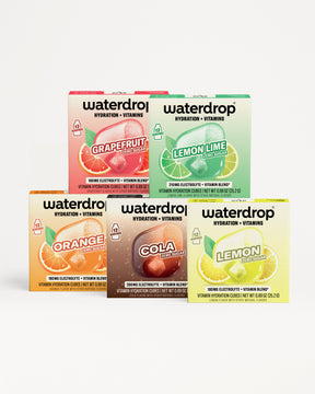 Assorted Waterdrop hydration and vitamin boxes stacked in a pyramid.