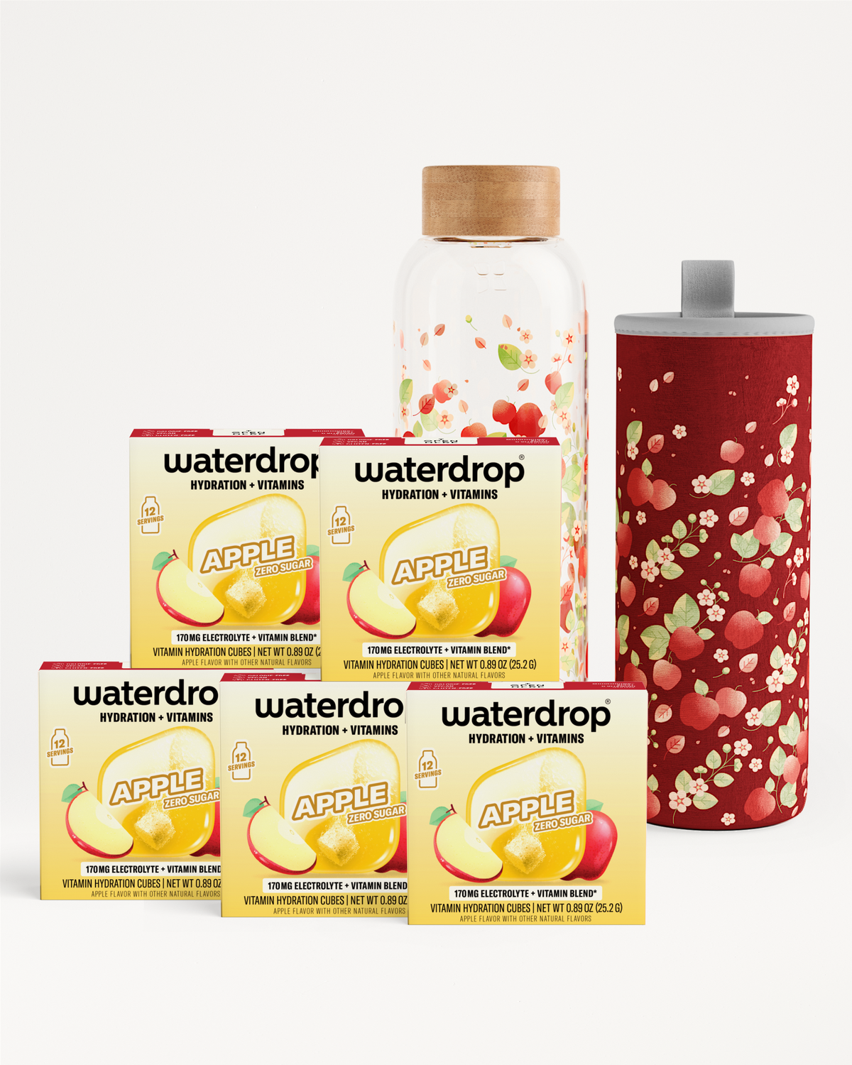 Assorted hydration and vitamin boxes with a glass bottle and a red speckled tumbler.