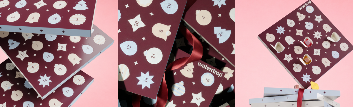 Collage of maroon gift cards with white festive icons beside a wrapped gift on a pink background.