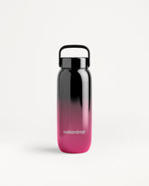 Gradient black-to-pink water bottle with a black cap and carrying handle.