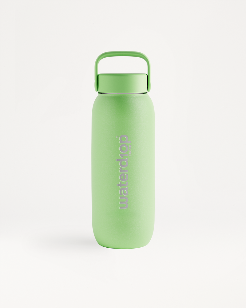 Green reusable water bottle with a matching green cap and built-in carrying handle, standing upright on a white background.