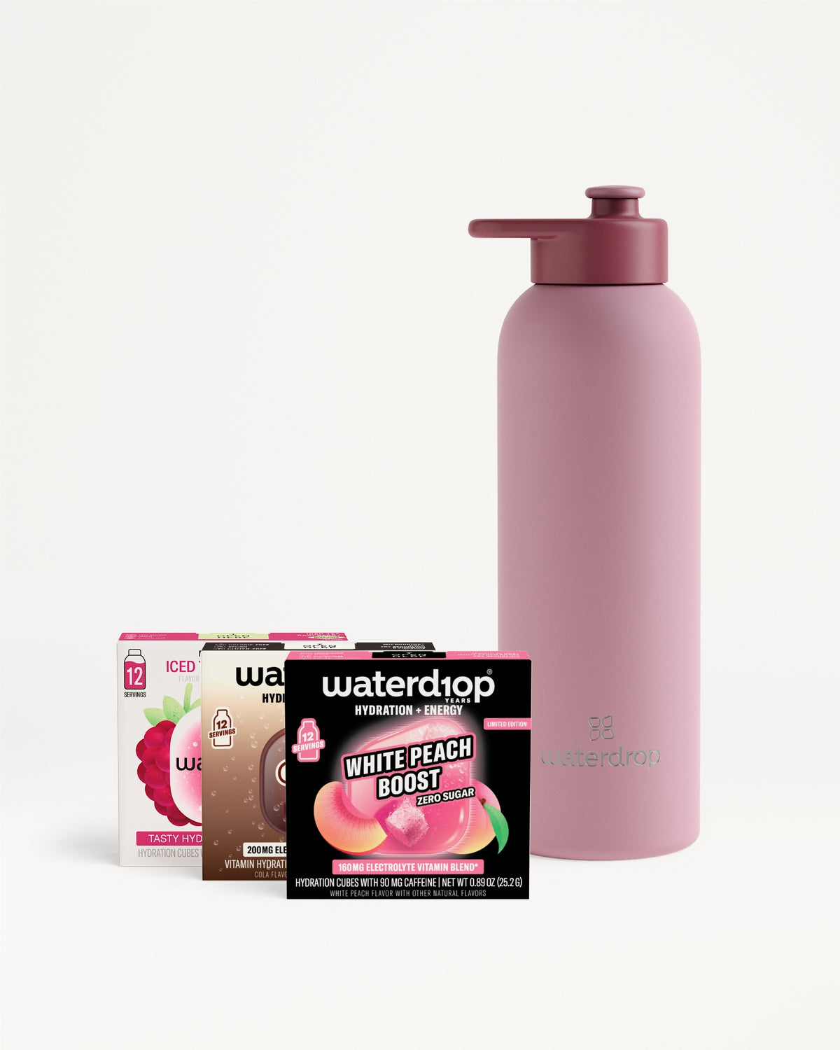 Pink reusable water bottle with a pump-cap and assorted boxed drink mix sachets.