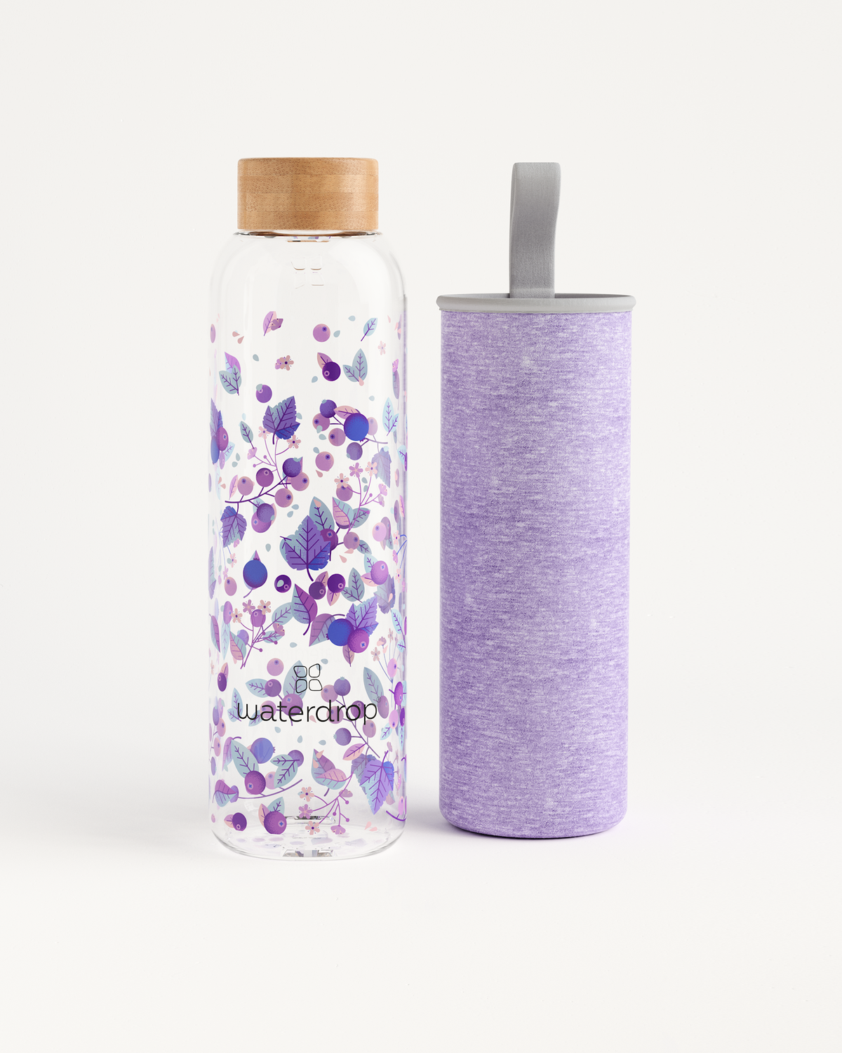 Clear glass water bottle with a wooden cap and purple floral pattern beside a matching lavender fabric sleeve.