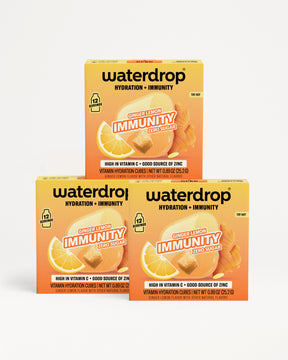 Three Waterdrop Hydration + Immunity boxes in orange flavor stacked on a white background.
