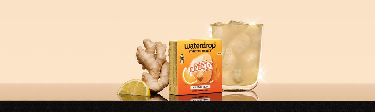 Box of flavoring tablets on a countertop with ginger and a lime wedge.
