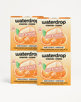 Four orange-flavored Waterdrop electrolyte and vitamin drink mix boxes stacked together