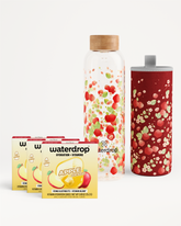 Hydration vitamin drop set with a glass bottle, two patterned tumblers, and boxed sachets.